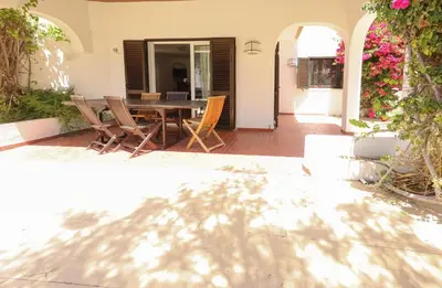 a patio with a wooden table and chairs at Villa Pedro - Swimming Pool - BY BEDZY in Albufeira