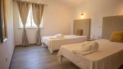 a room with two beds with towels on them at Villa Pedro - Swimming Pool - BY BEDZY in Albufeira