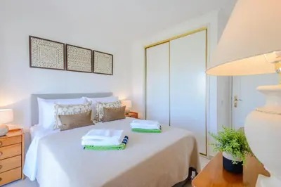 a bedroom with a bed with two towels on it at Casa Europa in Vilamoura
