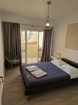 a bedroom with a bed with two towels on it at Apartamento T2 Palmeira Galé-Praia da Galé in Guia