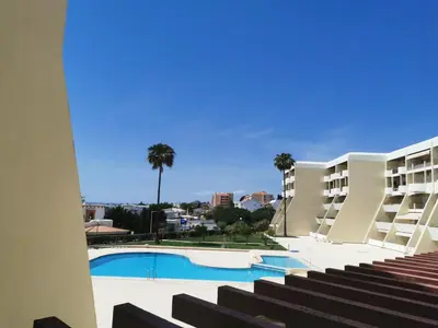 a view of the pool from the balcony of a hotel at Apartamento T2 Palmeira Galé-Praia da Galé in Guia
