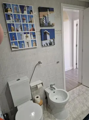 a bathroom with a white toilet and a sink at Apartamento T2 Palmeira Galé-Praia da Galé in Guia