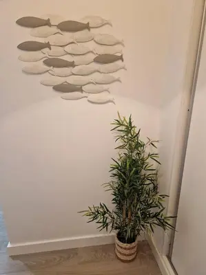 a group of towels hanging on a wall next to a plant at Apartamento T2 Palmeira Galé-Praia da Galé in Guia