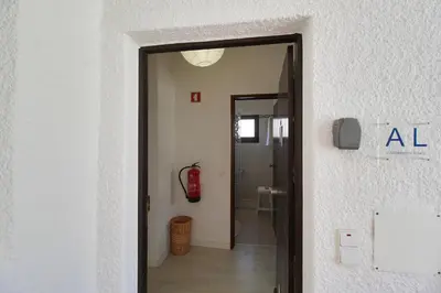 an open door to a hallway with a fire extinguisher at Apt 1 Quarto, Piscina, AC, Varanda, Prestige For Home in Vilamoura