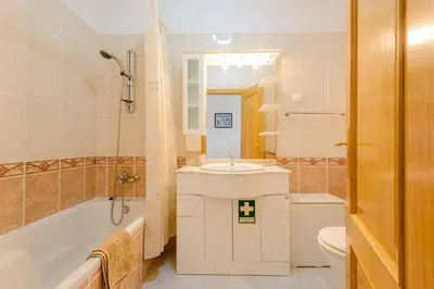 a bathroom with a tub and a sink and a toilet at Grevilias in Vilamoura