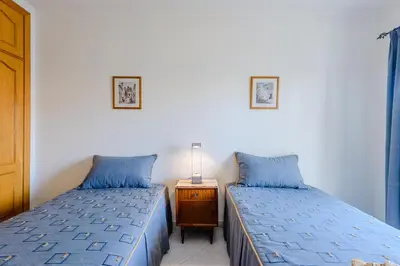 two beds sitting next to each other in a bedroom at Grevilias in Vilamoura