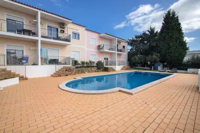 a swimming pool in front of a building at T1 Apartamentos Vista Alegre in Albufeira