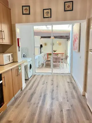 a kitchen with a sliding glass door leading to a dining room at Vila Sophia, Vilamoura- By Urbinvest Algarve in Vilamoura