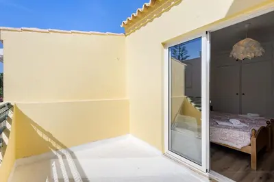 a sliding glass door leading to a patio with a bed at Vila Sophia, Vilamoura- By Urbinvest Algarve in Vilamoura