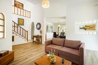 a living room with a couch and a table at Vila Sophia, Vilamoura- By Urbinvest Algarve in Vilamoura