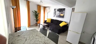 a living room with a black couch in a room at Historic Centre A - Albufeira in Albufeira