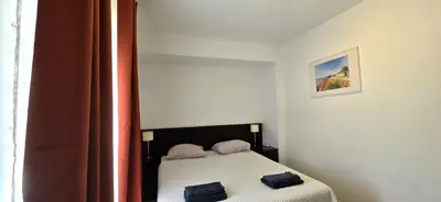 a white bedroom with a bed with white sheets at Historic Centre C - Albufeira in Albufeira