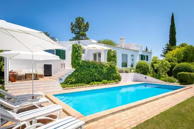 a villa with a swimming pool and a house at Villa Saragoça in Loulé