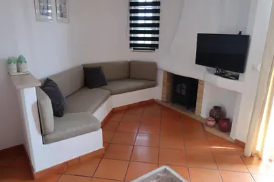 a living room with a couch and a flat screen tv at Apartamento Surpresa in Albufeira