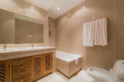 a bathroom with a sink and a toilet and a mirror at Villa 29 by Garvetur in Vale do Lobo