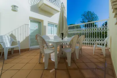 a white table and chairs on a balcony at Villa 29 by Garvetur in Vale do Lobo