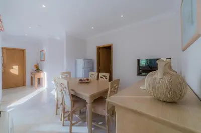 a kitchen and dining room with a table and chairs at Villa 29 by Garvetur in Vale do Lobo