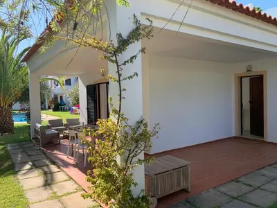 a white house with a deck and a patio at Falésia 25 in Albufeira
