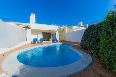 a swimming pool in the backyard of a house at Villa Bota by Garvetur in Almancil