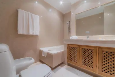 a bathroom with a toilet and a sink and a mirror at Villa Bota by Garvetur in Almancil