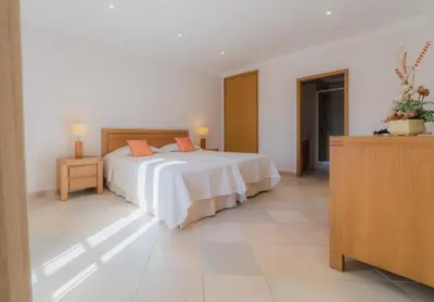 a bedroom with a bed and a dresser at Villa Bota by Garvetur in Almancil