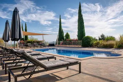 an aerial view of a house with a swimming pool at Casa Rosa - Heated Pool & Sea Views in Loulé