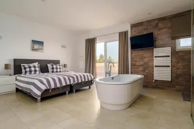 a living room with a couch and a table at Casa Rosa - Heated Pool & Sea Views in Loulé