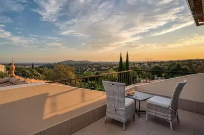 an outdoor patio with a pool and lounge chairs at Casa Rosa - Heated Pool & Sea Views in Loulé