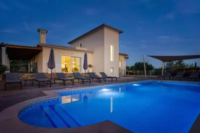 an outdoor entertaining area with a table and chairs at Casa Rosa - Heated Pool & Sea Views in Loulé