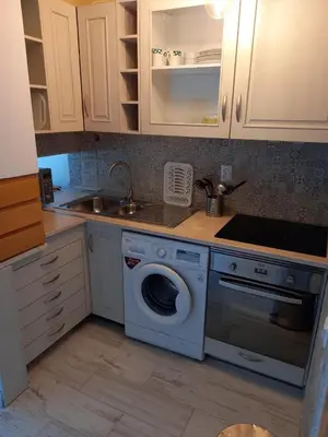 a kitchen with a washing machine and a sink at Quinta do Lago - Beach,Ténis, Bikes in Quinta do Lago