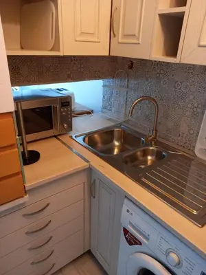 a kitchen with a sink and a microwave at Quinta do Lago - Beach,Ténis, Bikes in Quinta do Lago