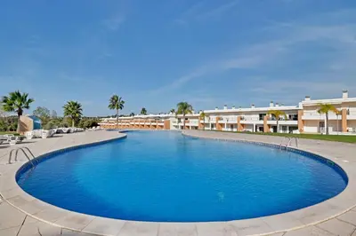 a large swimming pool in front of a resort at Albufeira Garden Villa With Pool by Homing in Albufeira