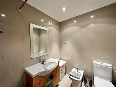 a bathroom with a sink and a toilet and a mirror at Albufeira Garden Villa With Pool by Homing in Albufeira