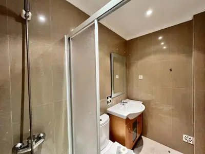 a bathroom with a toilet and a sink and a shower at Albufeira Garden Villa With Pool by Homing in Albufeira