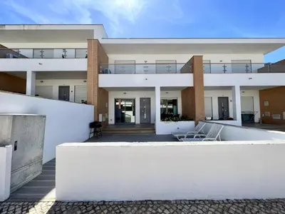 a house with white walls and a balcony at Albufeira Garden Villa With Pool by Homing in Albufeira