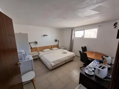 a bedroom with a bed and a desk and a table at AAA APARTAMENTS T0 Piscina Marina in Albufeira
