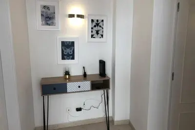 a small table in a room with a white wall at Le Modern' in Albufeira
