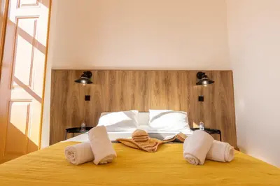 a bedroom with a bed with towels on it at GrowIN Digital Nomads in Faro