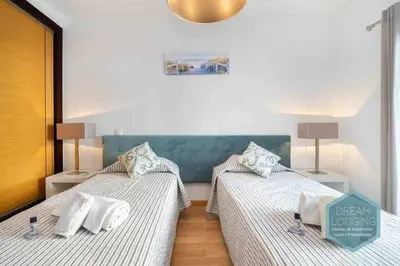 two twin beds in a room with two lamps at Terrace Miguel Torga - Dream Lodging in Albufeira