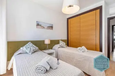 a bedroom with two beds with towels on them at Terrace Miguel Torga - Dream Lodging in Albufeira
