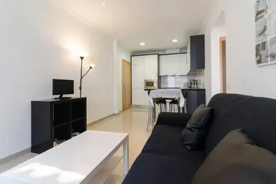 a living room with a couch and a dining room at De Hofnar Apartments Albufeira in Albufeira
