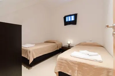 a room with two beds and a window at De Hofnar Apartments Albufeira in Albufeira