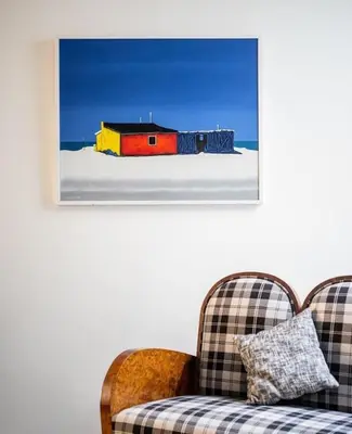 a living room with a couch and a picture of a house at Casa dos Retratos Faro in Faro