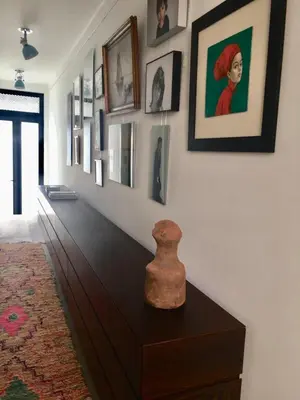 a room with a table with a vase on top of it at Casa dos Retratos Faro in Faro
