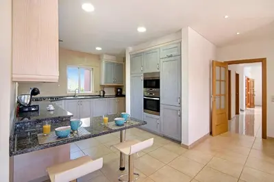a kitchen with a table and chairs in it at Casa Tulipas in Loulé