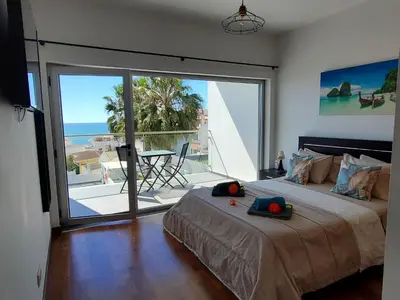 a bedroom with a bed with a view of the ocean at Villa beautiful View over the sea - T in Albufeira