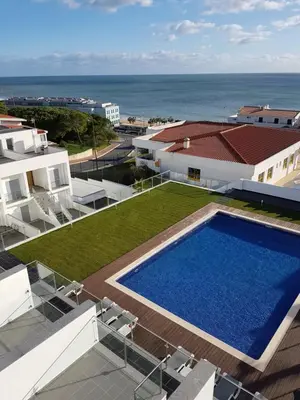 a swimming pool on top of a house with the ocean at Villa beautiful View over the sea - T in Albufeira