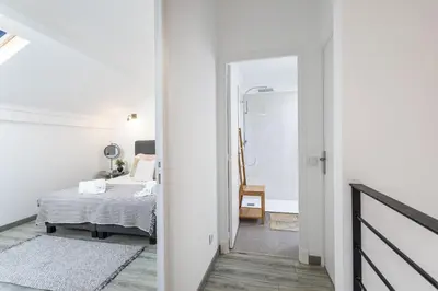 a bedroom with a bed and a walk in shower at Casa Lobo - 2 bedrooms - Duplex in Faro