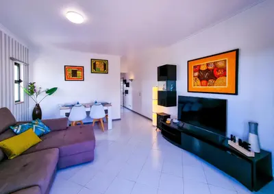 a living room with a couch and a tv at FLH Vilamoura Balcony with Pool in Vilamoura