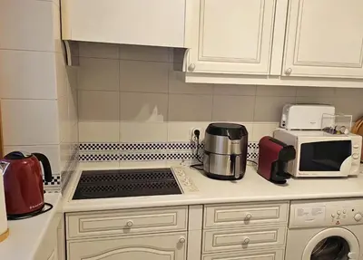 a kitchen with a stove top oven next to a microwave at Tivoli Apt8 with Pool&Garage in Vilamoura